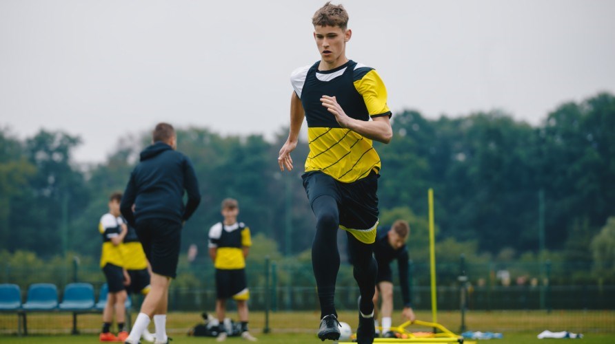 Ung kille som trnar med sitt lag.